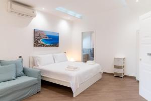 a white bedroom with a bed and a couch at MONDELLO COTTAGE in Mondello +81 photos