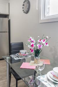 a glass table with a vase of flowers on it at 1BR Basement Condo - James Street in Hamilton