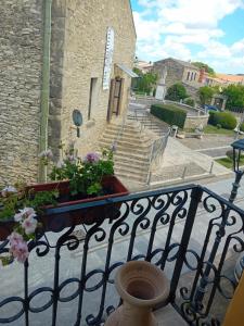 a balcony of a building with flowers on it at Su Mulinu 