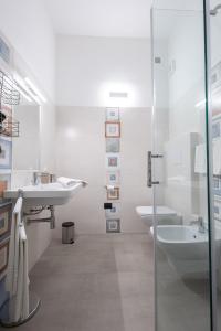 a white bathroom with a sink and a toilet at MaBi in Alghero