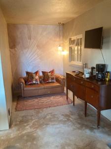 a living room with a couch and a table at Le Héritage in Klein-Drakenstein +70 photos