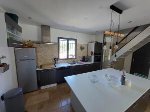 a kitchen with a white counter top in a room at Villa CALLY, chez MARIUS in Vidauban
