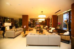 a large living room with couches and tables at Regina Palm Resort in Orikum