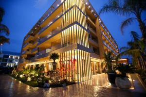a large building with lights on the side of it at Regina Palm Resort in Orikum