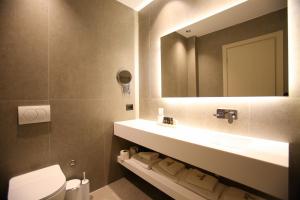 a bathroom with a sink and a mirror at Regina Palm Resort in Orikum