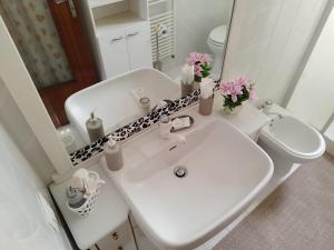 a bathroom with a sink and a toilet and a mirror at La Casa del Corso in Alberobello +33 photos