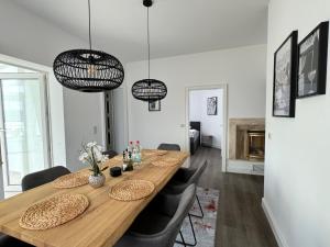 a dining room with a wooden table and chairs at 220 qm Penthouse Wohnung mit Fahrstuhl - ohne SPA in Mannheim