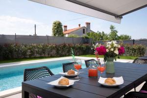 a black table with two plates of food on it at Villa Rudina in Pomer