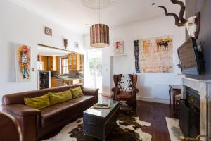 a living room with a couch and a fireplace at Sweetest Apartments in Cape Town