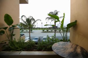 a window with a view of a parking lot at Regina Palm Resort in Orikum