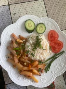 a plate of food with fries and rice and vegetables at CBT1 Sary-mogul in Sary-Mogul