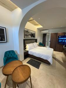 a bedroom with a bed and a table and a tv at Marea Seafront in Kalkara