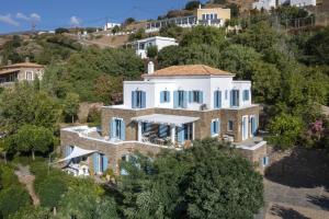 una vista aérea de una casa con ventanas azules en Seaside luxury villa, en Ándros