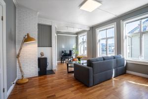 a living room with a couch and a table at Sunny apartment in Ålesund city in Ålesund