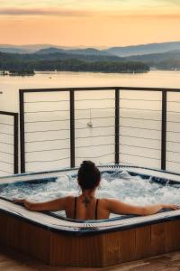 a woman in a jacuzzi tub on a deck at White Sails Solina in Solina