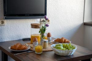 a table with plates of food and fruit on it at Ferienhof Kruse Wohnung 4 in Grömitz