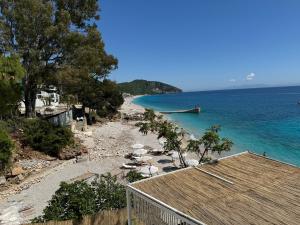 a view of a beach with a boat in the water at Apartment Olive in Dhërmi