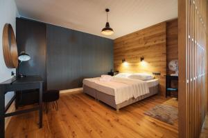 a bedroom with a bed and a desk and a desk at White Sails Solina in Solina