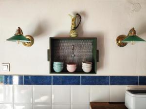 a kitchen with two lights and a shelf with pots at Henye Vintage Home a Káli-medencében in Balatonhenye +115 photos