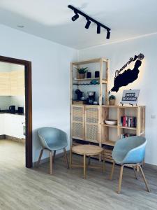 a room with two chairs and a book shelf at Trendy Villa Isabella in Playa Blanca