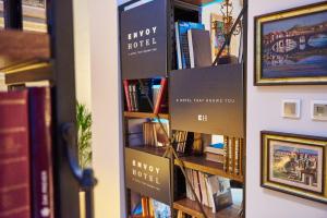 a book shelf filled with books in a library at Envoy Hotel in Belgrade