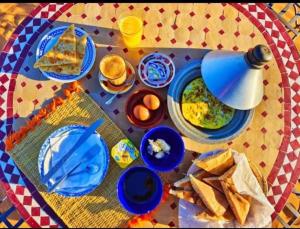 a table with plates of food on a table at Bright Star Desert Camp in Merzouga