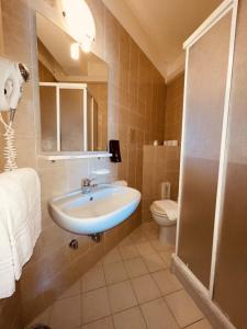 a bathroom with a sink and a toilet at Taki Village in Brenzone sul Garda