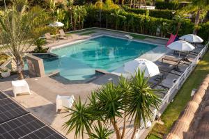 an overhead view of a swimming pool with chairs and umbrellas at Villa Solià - Villa indipendente con Piscina e Giardino in Campofelice di Roccella