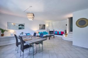 a living room with a table and chairs and a couch at Villa Cala Dor in Santanyi