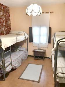 a room with two bunk beds and a window at 6 bedrooms house with private pool and enclosed garden at Burguillos de Toledo in Burguillos de Toledo