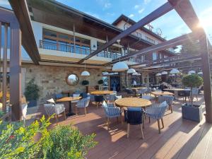 a patio with tables and chairs on a building at Apartments DreamBG in Sozopol