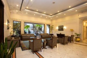 a lobby with couches and tables and a waterfall at Grand Hotel Kathmandu in Kathmandu
