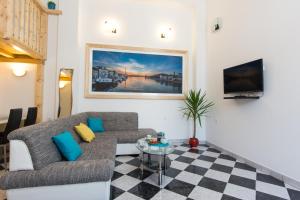 a living room with a couch and a table at Apartments Storia in Trogir
