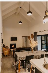 a living room with two tables and a fireplace at Robertson Halfway House in Robertson