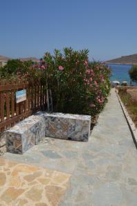 a bench sitting on a sidewalk next to a fence at Villa Aristoteles in Halki