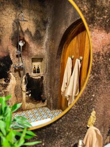 a bathroom with a wooden door and a mirror at Le Héritage in Klein-Drakenstein