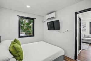 a small bedroom with a bed and a window at Tiny Homes in the Heart of Fort Lauderdale in Fort Lauderdale +21 photos