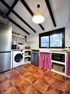 a kitchen with stainless steel appliances and a tile floor at Alojamiento Rural Viña El Labrador in Andújar