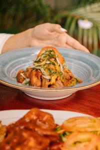 a blue plate of food on a table at Soy Local Guatape in Guatapé