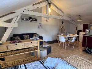a living room with a couch and a table at Aux Lofts de VERDUN in Verdun-sur-Meuse