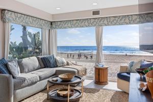a living room with a couch and a view of the beach at Brighton Adventure in San Diego