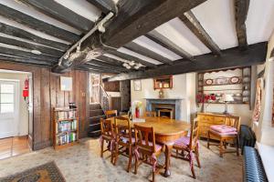 a dining room with a wooden table and chairs at Old Farmhouse in Hawkshead