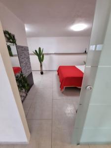 a room with a bed with a red blanket at !!!OFFERTA LAST MINUTE!!! LUSSUOSO appartamento NUOVO 300m dalla spiaggia in Torre Lapillo