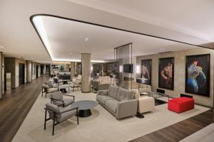 a lobby with couches and chairs and tables at 1881 Madrid Ventas Hotel in Madrid