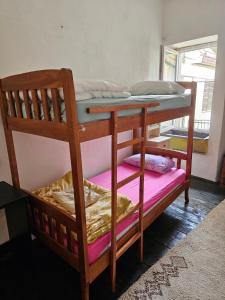 a bunk bed with a wooden bunk bed frame at Hostel Ka Doma in Cetinje