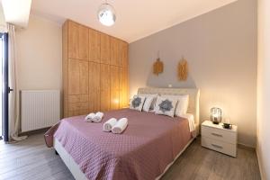 a bedroom with a bed with two towels on it at FoRest & sea view apartment in Argostoli