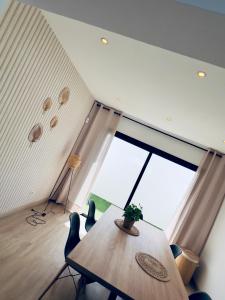 a dining room with a table and a large window at Trendy Villa Isabella in Playa Blanca