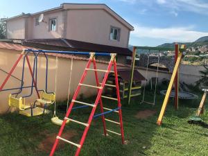 a group of playground equipment in front of a house at La Terrazza in Dobra Voda