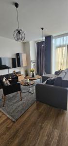 a living room with a couch and a table at Apartman Gold in Bugojno