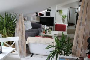 a living room with a couch and a tv at Schönes Loft 2 Personen 1-Raum 60qm in Meschede